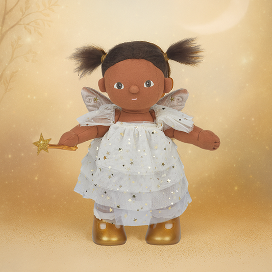 Fairy doll with a white dress, gold shoes, and a star wand on a gold background